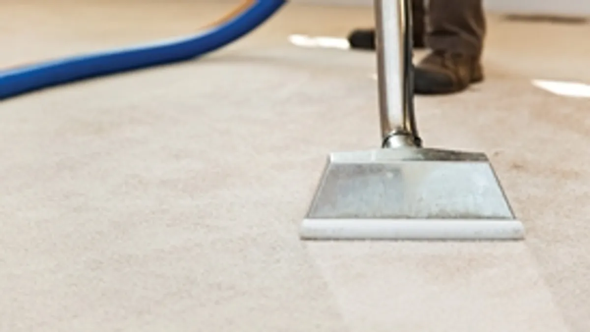 Carpet cleaning wand head gliding over a light carpet during hot-water extraction, Santa Ana, CA.